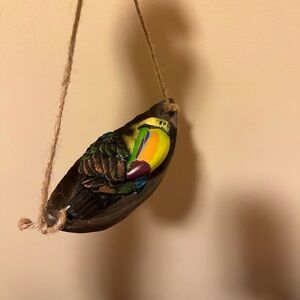 Sleeping Toucan bird hanging figurine.